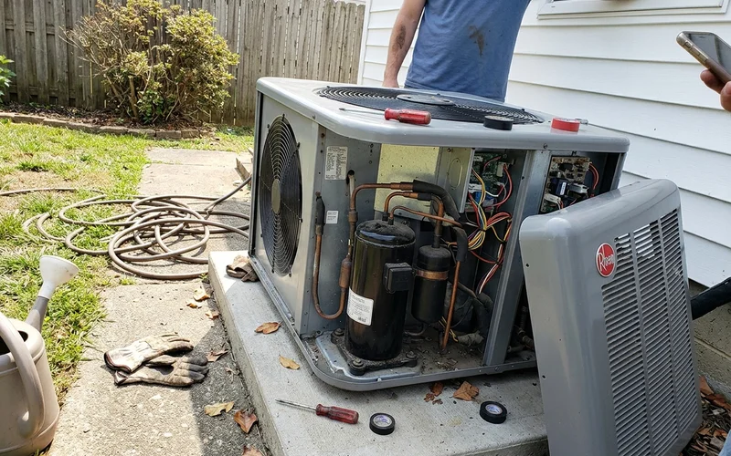 Close-up of a heat pump hot water compressor and fan unit