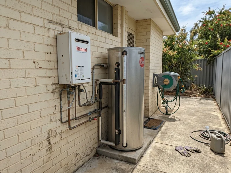 Gas booster unit beside a solar hot water tank