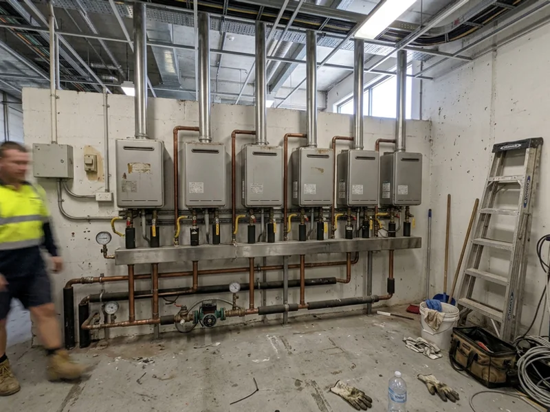 Commercial continuous flow units manifolded together in a plant room