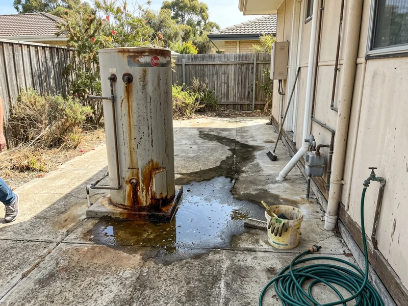 Water pooling under a corroded hot water tank